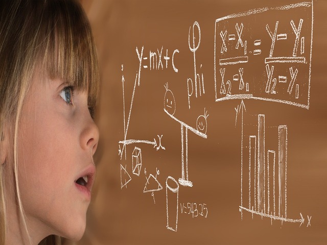 child in front of a board with math eqations